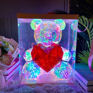 front view of cyber galaxy led bear with red heart in its display case, on table