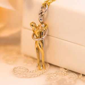 hug necklace for couples hanging from its giftbox