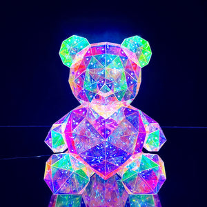 front view of cyber galaxy led bear with red heart in its display case, on table