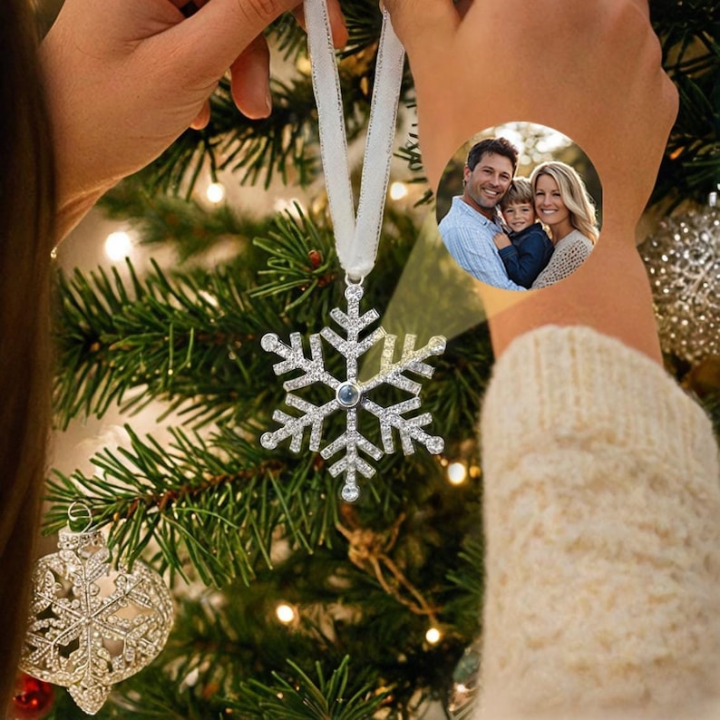 two hands holding the snowflake christmas ornament 